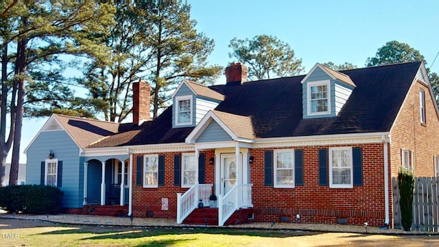 cape cod-style house featuring a front yard