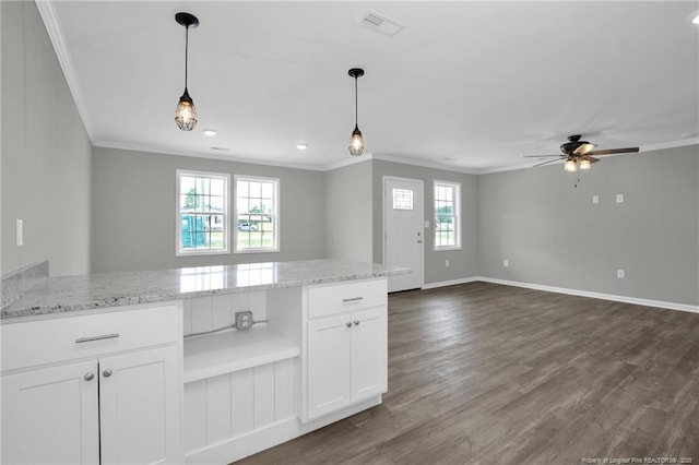 kitchen featuring ceiling fan, white cabinets, light stone countertops, and a healthy amount of sunlight