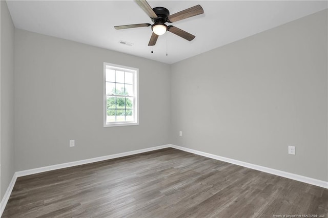 empty room featuring ceiling fan and dark hardwood / wood-style flooring