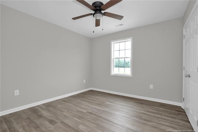 empty room with ceiling fan and hardwood / wood-style flooring