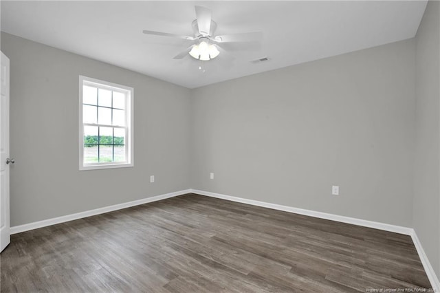 unfurnished room featuring ceiling fan and dark wood-type flooring