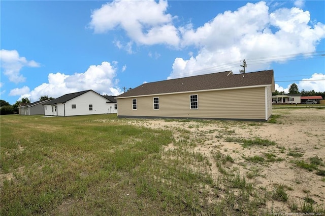 back of house with a lawn