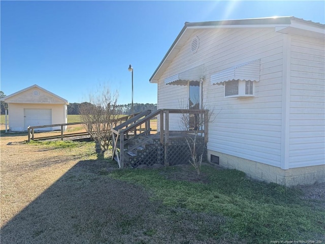 view of home's exterior featuring a garage, an outbuilding, and a lawn