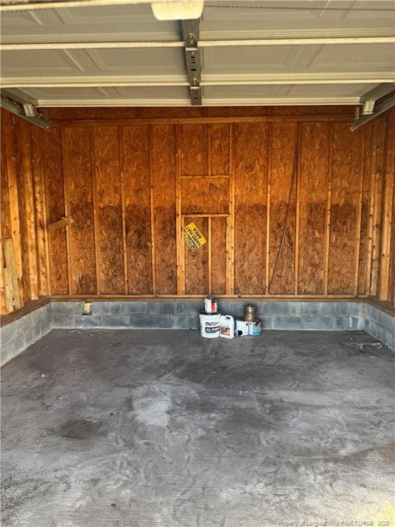 garage featuring wood walls