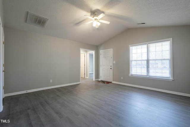 empty room with a textured ceiling, ceiling fan, dark hardwood / wood-style flooring, and lofted ceiling