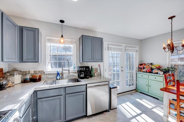 kitchen featuring dishwasher, french doors, sink, decorative light fixtures, and stove