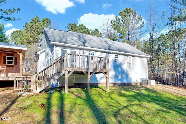 rear view of property featuring a lawn and a wooden deck