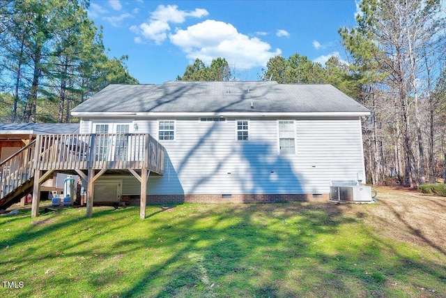 back of property with central air condition unit, a wooden deck, and a yard