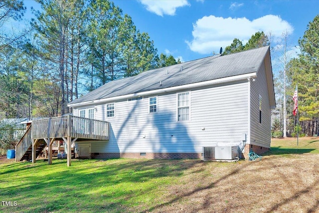 back of house with central air condition unit, a lawn, and a deck