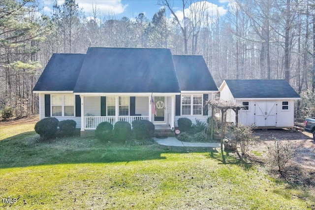 view of front facade featuring a porch, a front yard, and a shed