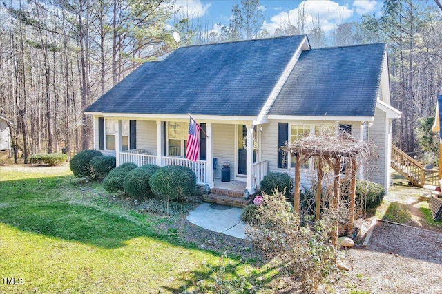 view of front of home with a front yard and a porch