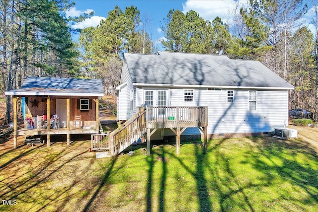 back of house with a deck, cooling unit, and a lawn