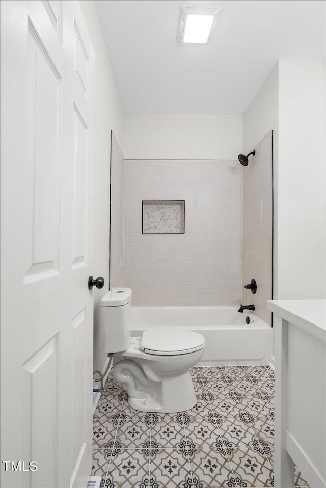 bathroom with tiled shower / bath combo and toilet