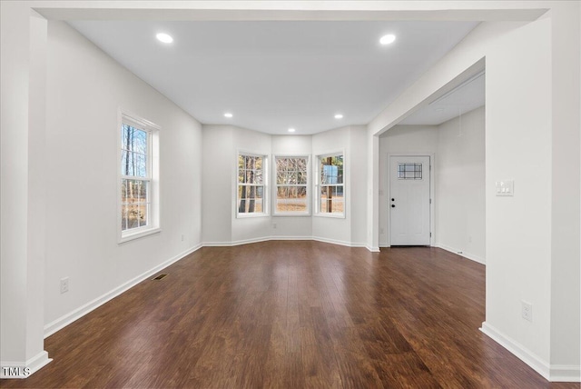 interior space featuring a wealth of natural light and dark hardwood / wood-style floors