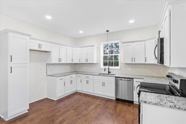 kitchen with sink, white cabinetry, decorative light fixtures, dark hardwood / wood-style floors, and stainless steel appliances