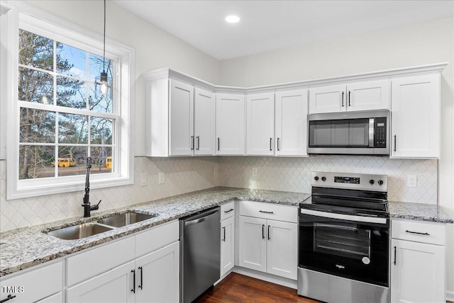 kitchen featuring sink, white cabinets, and appliances with stainless steel finishes