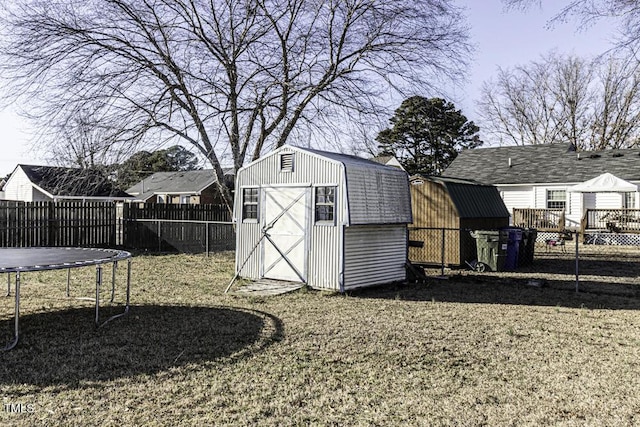 view of outdoor structure with a trampoline and a yard