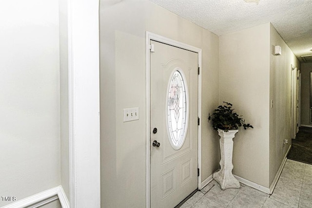 foyer with a textured ceiling