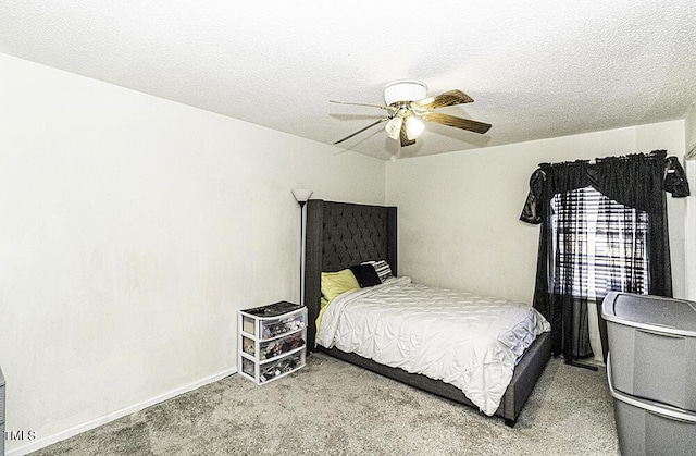 bedroom featuring a textured ceiling, ceiling fan, and carpet flooring