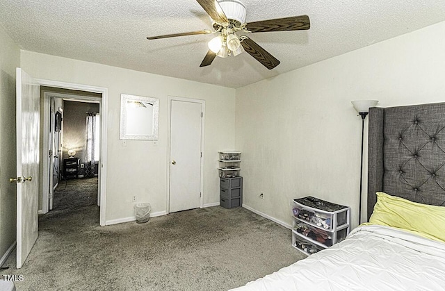 bedroom with ceiling fan, carpet floors, and a textured ceiling