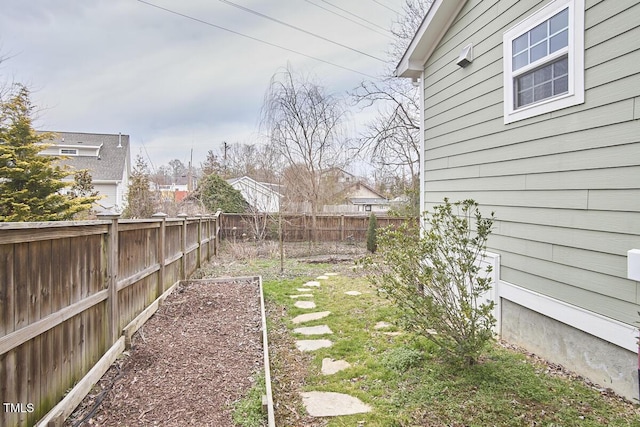 view of yard featuring a fenced backyard and a vegetable garden