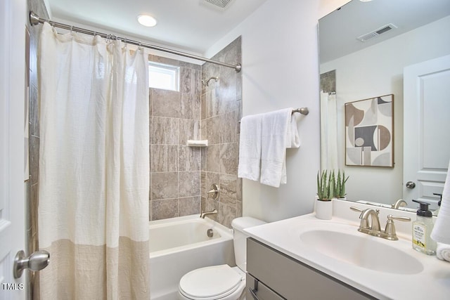 full bathroom with toilet, shower / bath combo, visible vents, and vanity