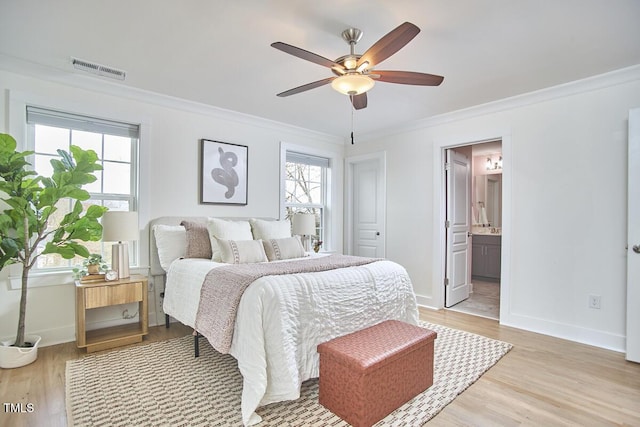 bedroom with ornamental molding, multiple windows, light wood-type flooring, and visible vents