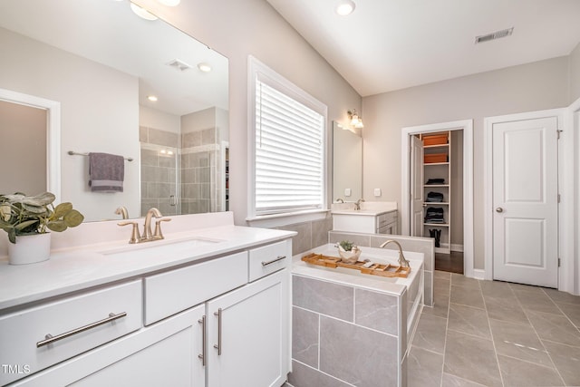 bathroom featuring vanity, an enclosed shower, and tile patterned flooring