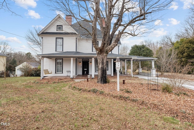 view of front of home with covered porch and a front lawn