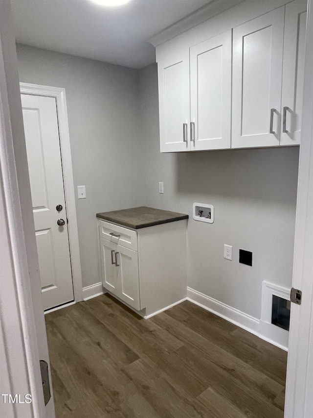 laundry room with cabinets, washer hookup, and dark hardwood / wood-style flooring