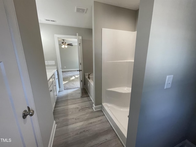 bathroom featuring vanity, shower with separate bathtub, and hardwood / wood-style flooring