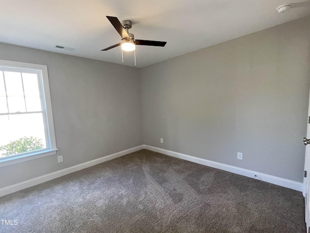 carpeted spare room with ceiling fan