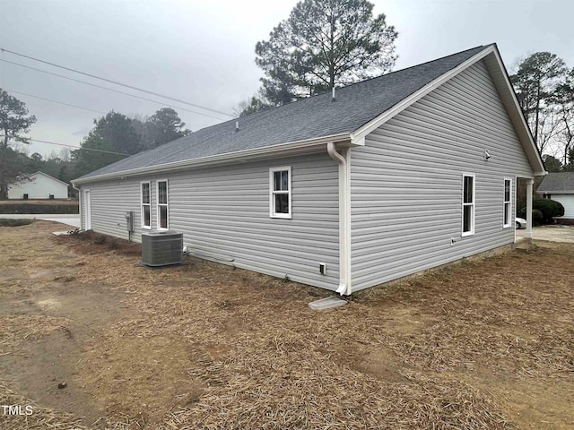 view of side of home with central AC unit