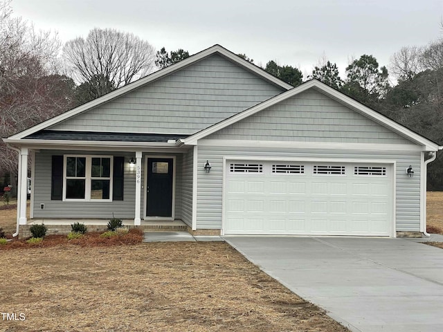 view of front facade featuring a porch and a garage