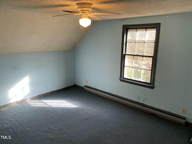 additional living space featuring lofted ceiling, ceiling fan, carpet flooring, a textured ceiling, and a baseboard radiator