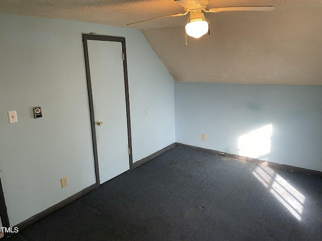 bonus room featuring lofted ceiling, ceiling fan, and a textured ceiling