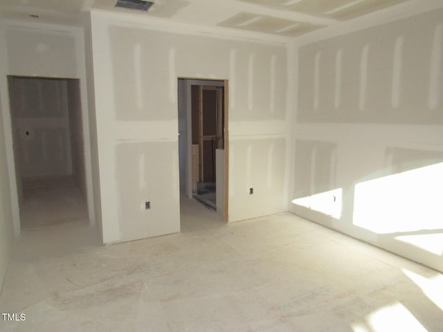 unfurnished room with visible vents