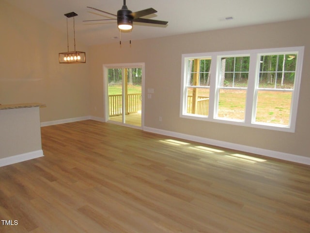 122 Beaver Trl, Littleton, NC 27850 - unfurnished living room with baseboards, light wood finished floors, and a ceiling fan