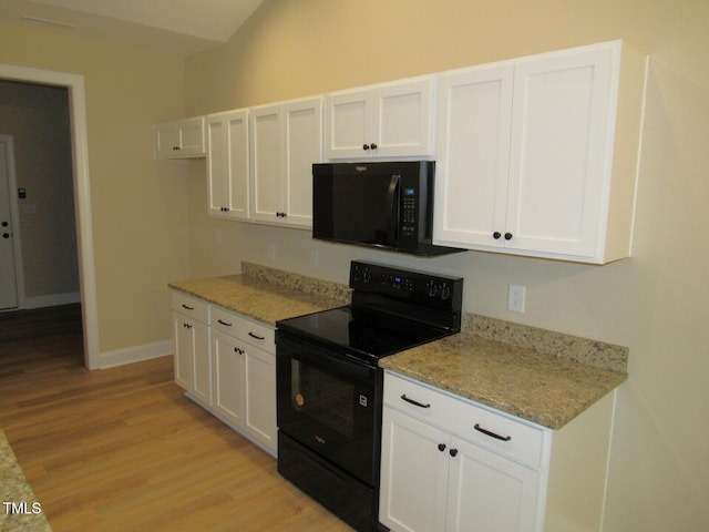 122 Beaver Trl, Littleton, NC 27850 - kitchen with black appliances, light wood-style flooring, white cabinetry, and light stone countertops