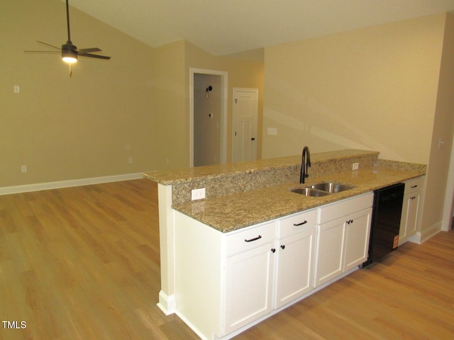 122 Beaver Trl, Littleton, NC 27850 - kitchen with a sink, black dishwasher, light wood-style floors, a peninsula, and lofted ceiling