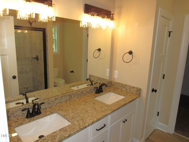 122 Beaver Trl, Littleton, NC 27850 - full bathroom with a chandelier, toilet, a shower stall, double vanity, and wood finished floors