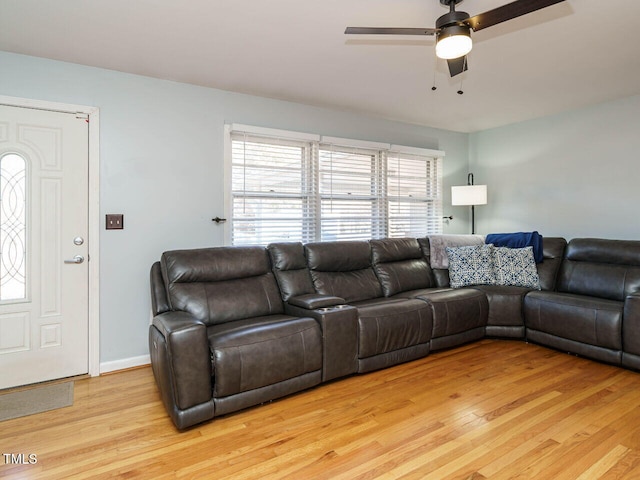 living room with ceiling fan and light hardwood / wood-style flooring