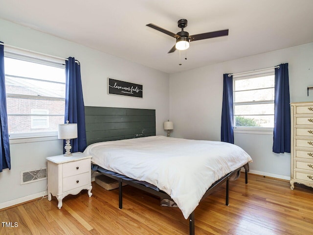 bedroom featuring light wood-type flooring and ceiling fan