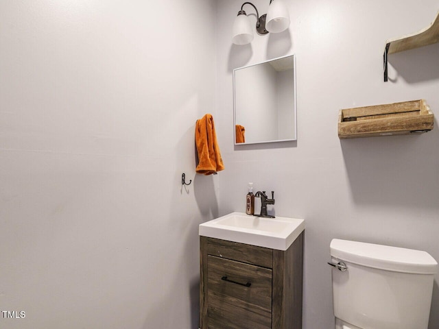 bathroom featuring toilet and vanity