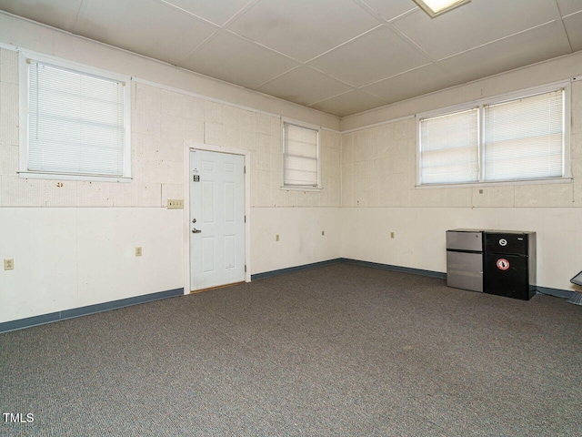 spare room featuring dark colored carpet