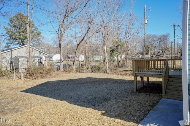 view of yard with a storage unit and a deck