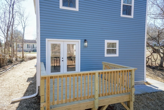 back of property featuring a wooden deck and french doors