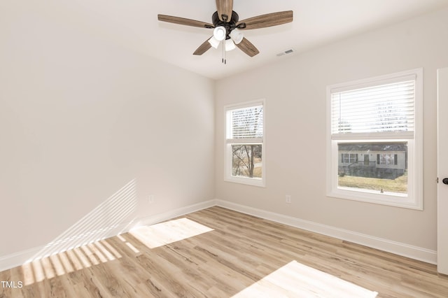 spare room with ceiling fan and light wood-type flooring