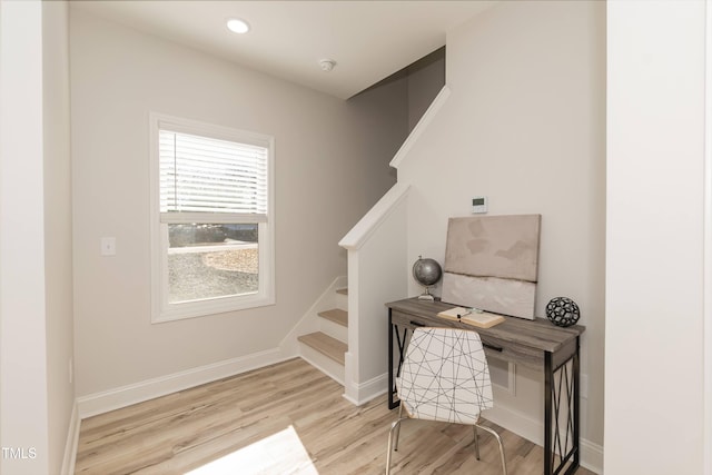 staircase with hardwood / wood-style floors