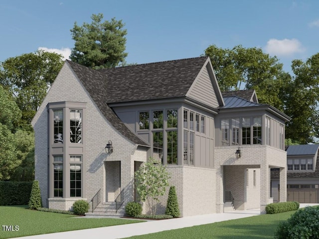 view of front facade featuring a shingled roof, a standing seam roof, brick siding, and a front lawn